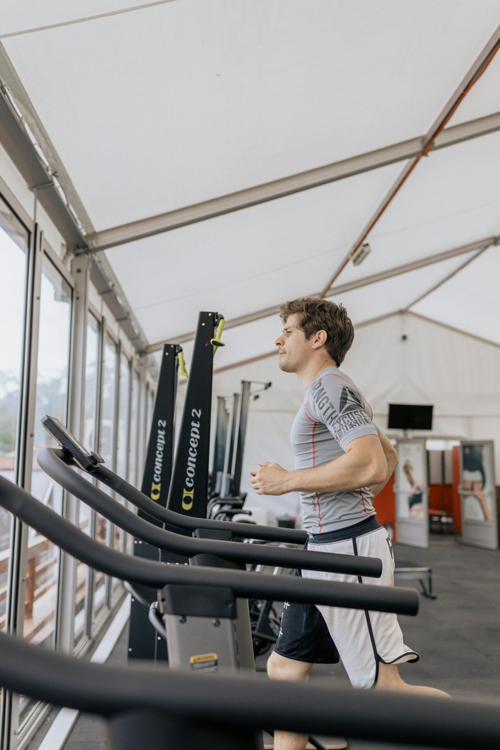 Man exercising on treadmill in a modern indoor gym. Healthy lifestyle captured in action shot.