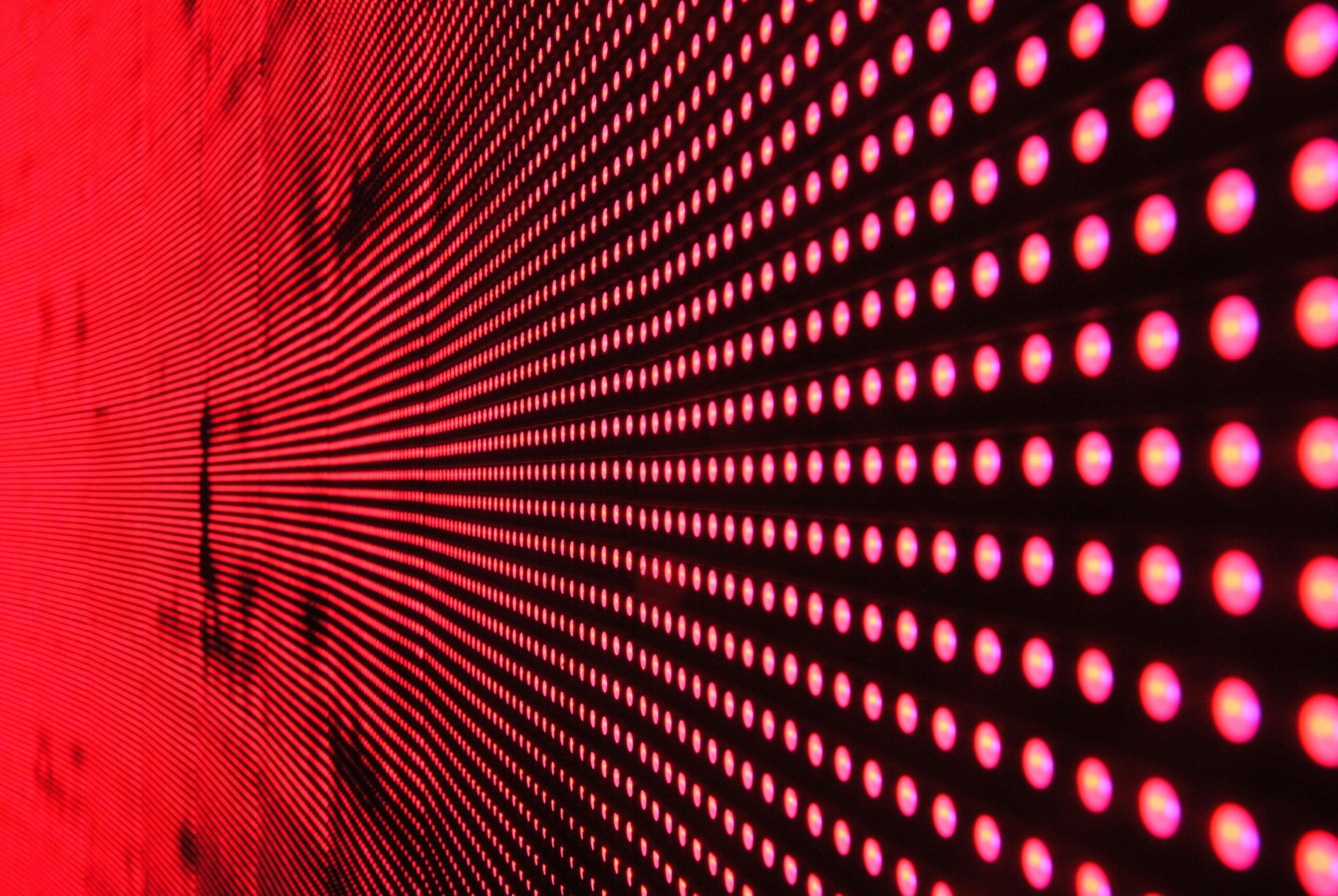 Vibrant abstract pattern of illuminated red LED lights forming a dynamic design.